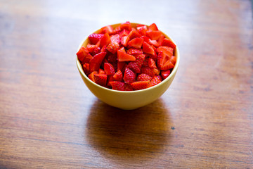 strawberry  in a bowl on wood table