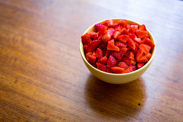 strawberry  in a bowl on wood table