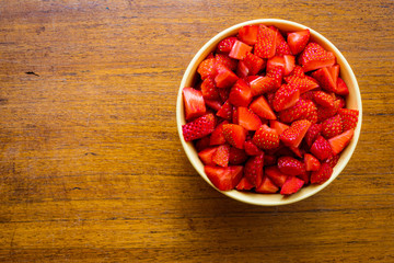 strawberry  in a bowl on wood table