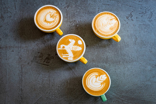 coffee cup with latte art on a dark background