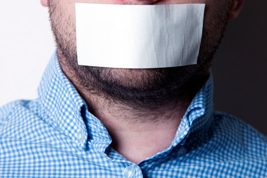 Man With Sticky Tape Over His Mouth, White Background
