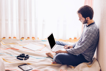 boy sitting on the floor with a laptop