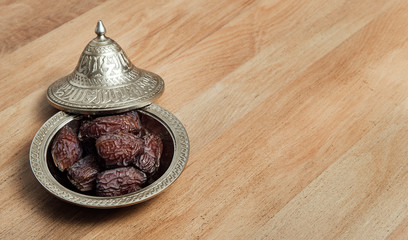 Dates fruit on wooden table. The Muslim feast of the holy month of Ramadan. Writeable background.