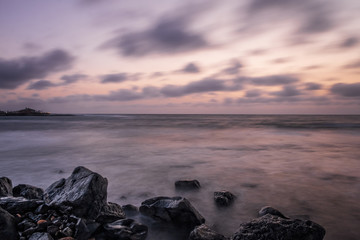 Fototapeta premium Waves on the Atlantic Ocean at sunrise. Caleta de La Guirra Beach, Fuerteventura, Canary islands, Spain. October 2019. Long exposure shot.