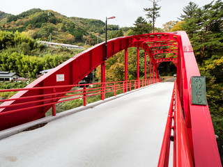 Red bridge over the Kiso river at Kiso-no-Kakehashi, a scenic spot in Kiso valley