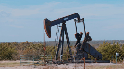 Oil pump in the countryside of Oklahoma - Pump jack - USA 2017