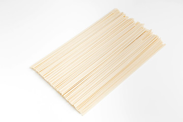 Raw udon noodles on white, horizontal photo