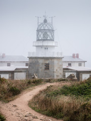 Fototapeta na wymiar Punta Estaca de Bares Lighthouse on a foggy summer day, Galicia, Spain