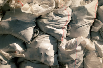 White construction garbage bags. Construction garbage bags piled on top of one another. A large pile of construction garbage bags. abstract background