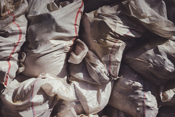 White construction garbage bags. Construction garbage bags piled on top of one another. A large pile of construction garbage bags. abstract background