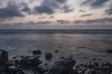 Waves on the Atlantic Ocean at sunrise. Caleta de La Guirra Beach, Fuerteventura, Canary islands, Spain. October 2019. Long exposure shot.