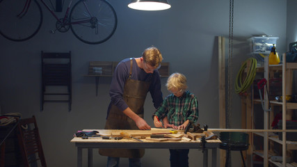 Dad measures the board with a ruler. Stay home