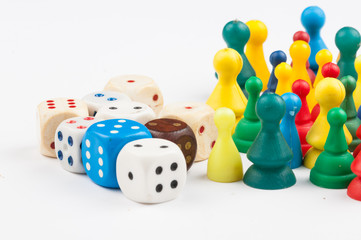 Colorful play figures with dice isolated on white background.Copy space