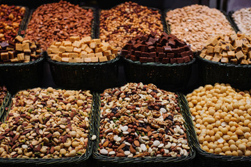 Different nuts in wooden baskets for sale at the market