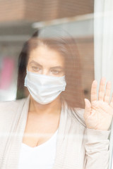 woman with sanitary mask through the window