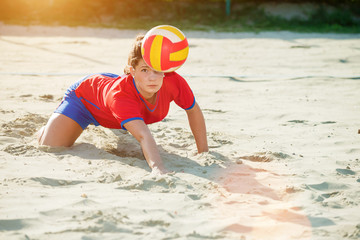 Young professional female volleyball player in an action.Copy space, lens flare