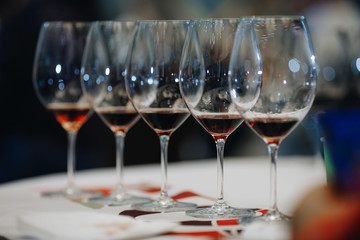 Red wine pouring into wine glass, close-up