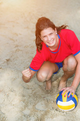 High angle view of young, happy volleyball player girl says ,,yes,,. Lens flare