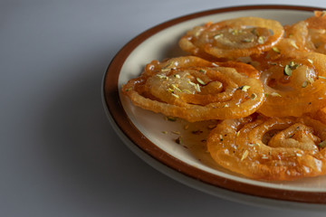 jalebi garnished with pistachio in a plate
