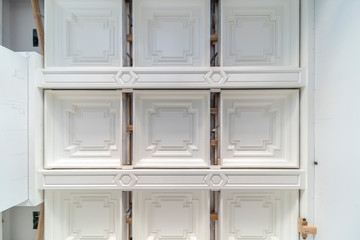 White square coffered ceiling installation with designer beams