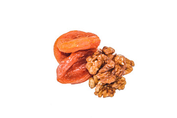 Close up view of walnut and dried apricots isolated on white. Heap of walnut and dried apricots as background. Macro view of walnut and dried apricots.