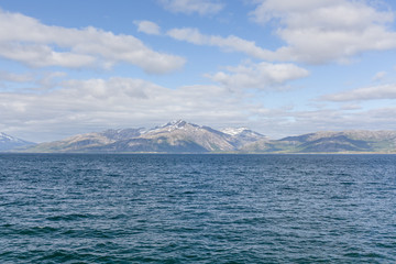 Beautiful view of the Norwegian fjords with turquoise water surrounded by cloudy sky, selective focus