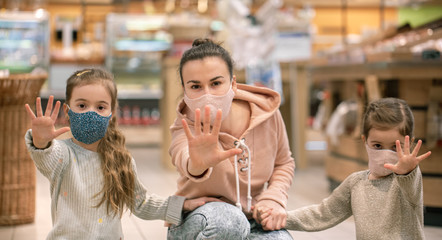 Mom and kids are shopping at the grocery store.