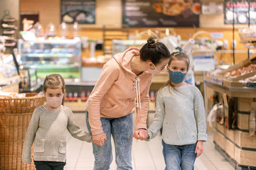 Mom and kids are shopping at the grocery store.