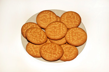 Round cookies in a plate on a white background