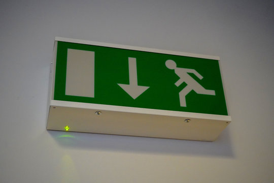 Emergency exit sign hanging on a wall