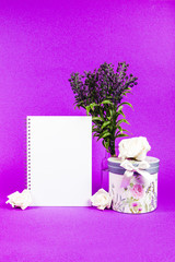 Blank notebook with lavender flowers and floral box on a purple background