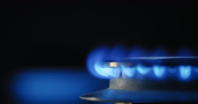Blue Flame Burning in Gas Kitchen Stove. Slow Motion and Copy Space