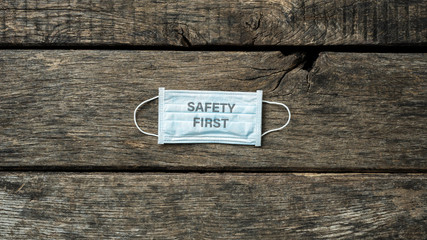 Safety first sign printed on medical protective mask
