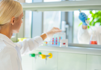 Scientist and students working in lab. Doctor teaching interns to make blood analyzing research. Coronavirus, chemistry, bacteriology, virology and health care