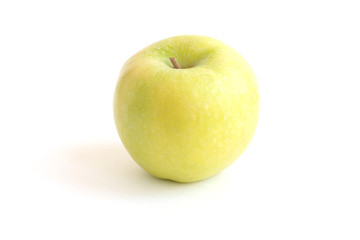 Beautiful fresh green Golden Delicious apple with stem on the top isolated on white background. Cooking Ingredients Theme.