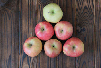 Green and red apple on dark background