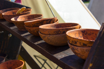 Handmade pottery on a wooden shelf