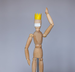 Wooden dummy in a medical mask during the epidemic period of the coronavirus virus COVID 19.