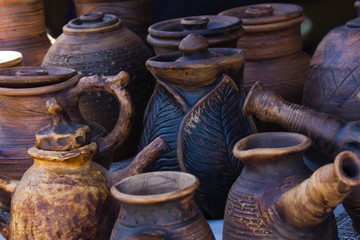 Handmade clay dishes, jugs  closeup, abstract background