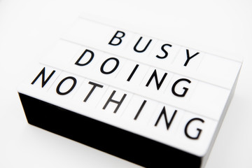 Busy doing nothing, inspirational text written on a light box.