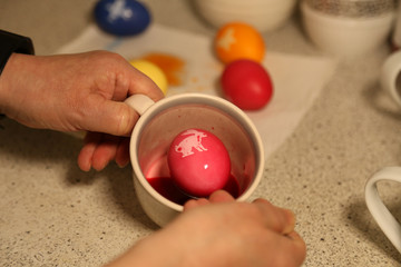 Painting Easter eggs. Painting eggs for easter holiday celebration.