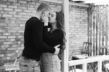 couple in blue jeans and black shirts in a green park