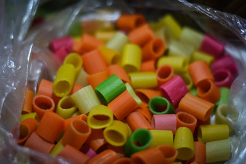 close up of colorful candies on bowl 