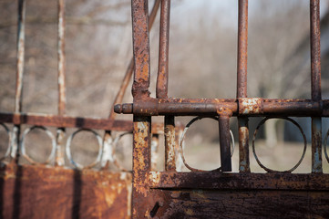 old rusty iron gate with a deadbolt
