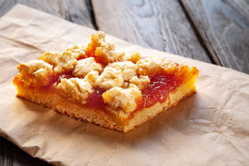Homemade apricot pie. A slice of rustic hot sweet pie on parchment. Natural organic food. Selective soft focus.