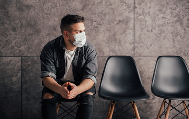 Young man with black mask in dark room pray for world and coronavirus quarantine