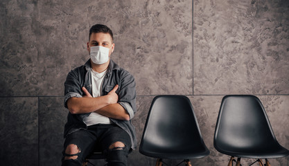 Young man with black mask in dark room pray for world and coronavirus quarantine