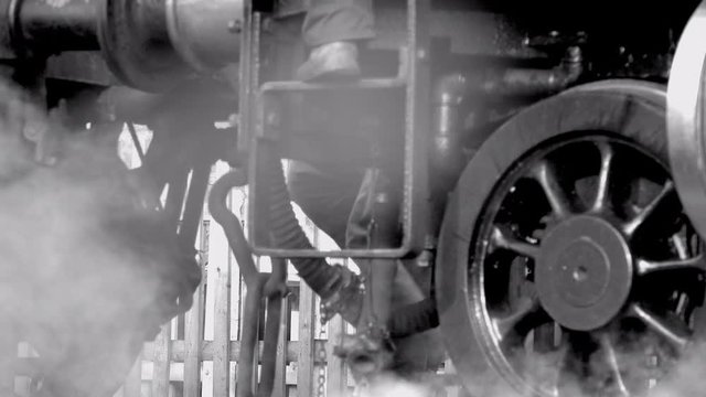 Steam train close up of wheels moving on track UK 4K