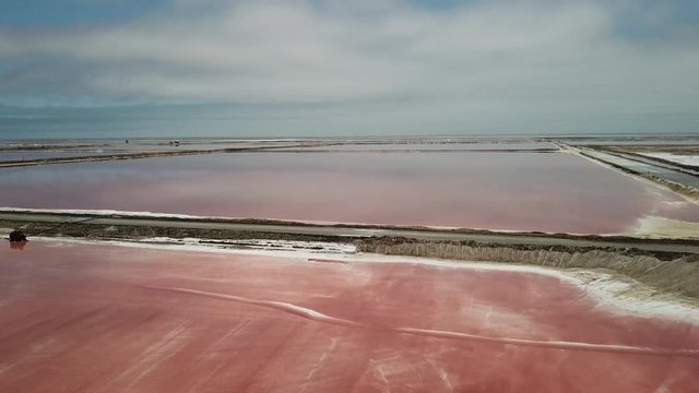 4K aerial drone video of salt works factory wide pink salty water evaporation ponds, in outskirts of coastal harbour town Walvis Bay, Namib Desert, Atlantic Ocean west coast, Namibia, southern Africa