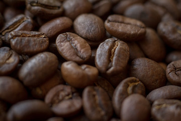 Extremely close-up background roasted coffee beans with gold streaks, good morning concept